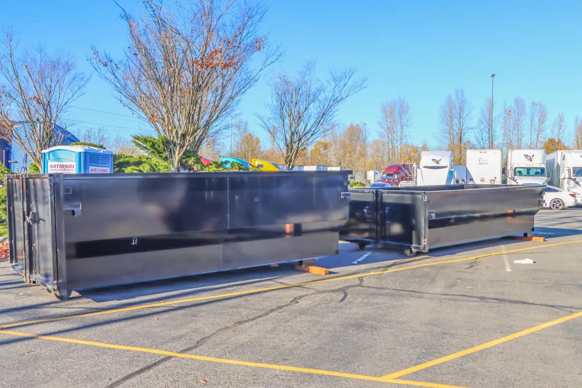 Professional dumpster rental service with roll-off container on residential driveway in Reserve